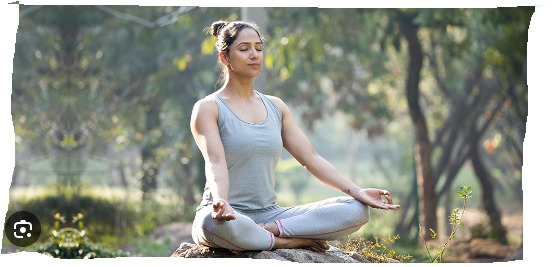 A person practicing yoga on a calm beach, demonstrating a gentle asana to highlight safe yoga practice post-meal or on an empty stomach.